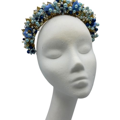 Stunning hand beaded multi-tonal blue crown with gold hardware detail.